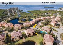 Aerial view of waterfront community with luxurious homes and private pools at 1545 Citrine Trl, Tarpon Springs, FL 34689