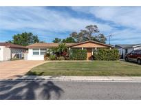 House exterior showcasing a manicured lawn and driveway at 3337 Darlington Rd, Holiday, FL 34691