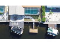 Aerial view showing home, pool, boat dock, and canal access at 13541 Stacey Dr, Hudson, FL 34667