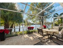 Enjoy the lake view from this screened patio with seating at 4886 Westchester Ct, Oldsmar, FL 34677