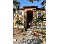 Building exterior with landscaped grounds and walkway at 2199 Chianti Pl # 9-0917, Palm Harbor, FL 34683