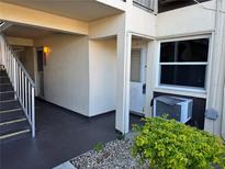 Exterior view of condo building entrance with stairs and landscaping at 5142 Topaz Ln # 103, New Port Richey, FL 34652