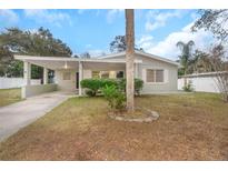 Charming single story home with carport and well-manicured lawn at 5931 Pine St, New Port Richey, FL 34652