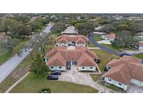 Aerial view of a community of villas with brown roofs and green exteriors at 8350 High Point Cir # 3, Port Richey, FL 34668