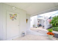 Inviting front patio with seating area and colorful flowers at 3920 Trophy Blvd # 6, New Port Richey, FL 34655