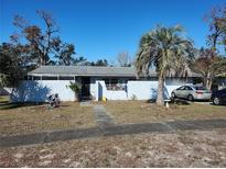 Ranch style home with carport and mature landscaping at 4230 Lee Rd, Spring Hill, FL 34608