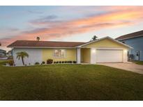 Updated single story home with a landscaped lawn and attached garage at 4270 Paradise Cir, Hernando Beach, FL 34607