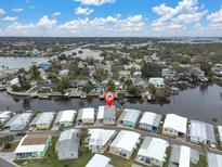 Aerial view showing home's waterfront location and surrounding neighborhood at 54 Schooner Dr # 54, Palm Harbor, FL 34683