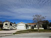 Single-story house with a two-car garage and RV parking at 7129 Beachdale Ct, Port Richey, FL 34668
