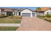 Two-car garage and paver driveway, charming curb appeal at 11061 Egeria Dr, Odessa, FL 33556