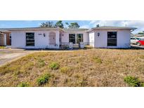 White single-story home with a spacious yard at 1333 Normandy Blvd, Holiday, FL 34691