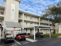 Two-story building with covered parking and golf cart spaces at 21103 Patio View Ct # 3105, Lutz, FL 33558