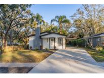 Newly renovated home with a modern exterior and landscaped front yard at 405 Pine S Ave, Oldsmar, FL 34677