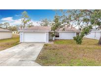 House exterior with driveway and lawn at 8003 Blackhawk Trl, Spring Hill, FL 34606