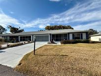 Neat ranch-style home with carport and well-manicured lawn at 11141 Sandtrap Dr, Port Richey, FL 34668