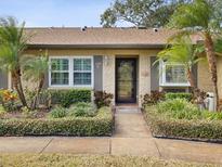 House exterior with landscaped yard and walkway at 3259 Hilary Cir # 1C, Palm Harbor, FL 34684