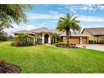 Beautiful home with three-car garage and lush landscaping at 3414 Graycliff Ln, Brandon, FL 33511