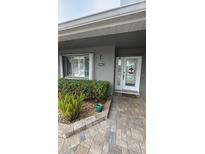 Inviting front entrance with landscaped walkway and updated door at 5341 Windward Way, New Port Richey, FL 34652