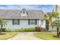 Charming light blue house with palm trees and manicured lawn at 6033 Wilds Dr # 6033, New Port Richey, FL 34653