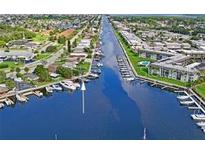 Aerial view showing waterfront property with boat slips and canal access at 4907 Floramar Ter, New Port Richey, FL 34652