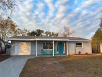 Newly renovated home with a teal front door and landscaped lawn at 7325 Ivanhoe Dr, Port Richey, FL 34668