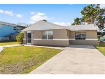 Cute bungalow with a large front yard and driveway at 13637 Lagoon Dr, Hudson, FL 34667