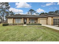 Cute one-story home with stone accents and a two-car garage at 7267 Prince George Ct, Spring Hill, FL 34606