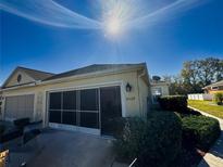 Tan house with garage and landscaped yard at 8524 Corinthian Way, New Port Richey, FL 34654