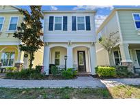 Two-story townhome with front porch and landscaping at 105 Cutlass Way, Oldsmar, FL 34677