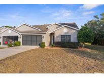 Cute two-bedroom villa with a screened-in porch and attached garage at 410 Candlestone Ct, Spring Hill, FL 34609