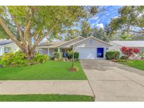 Attractive single-story home with a well-manicured lawn and driveway at 4710 Parkdale Ln, New Port Richey, FL 34655
