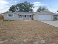 Ranch style home with a large yard and attached garage at 7538 Bougenville Dr, Port Richey, FL 34668
