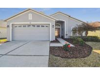 Charming single-story home featuring a well-manicured lawn and a two-car garage at 11637 Spindrift Loop, Hudson, FL 34667