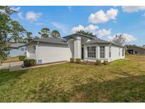 Charming single Gathering home with a manicured lawn and lovely landscaping at 11744 Wheatfield Loop, Hudson, FL 34667