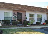 Well-maintained condo building with attractive landscaping and individual unit entrances at 6124 Chesham Dr # 6, New Port Richey, FL 34653