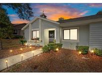 Charming home exterior featuring landscaped yard, walkway lights, and unique architectural details at 8194 Sturbridge Ct # A, Weeki Wachee, FL 34613