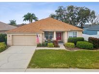 Charming single-story home featuring a well-maintained lawn and a welcoming front porch at 8709 Maple Pond Ct, Trinity, FL 34655