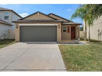 Charming single-story home featuring a two-car garage, well-maintained lawn, and welcoming front entrance at 13357 Marble Sands Ct, Hudson, FL 34669