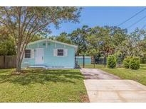 Charming one-story home with a well-maintained lawn and classic architectural details at 1888 Douglas Ave, Dunedin, FL 34698