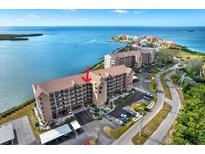 Beautiful waterfront condominium building with lush landscaping, ample parking, and serene ocean views at 4620 Bay Blvd # 1154, Port Richey, FL 34668