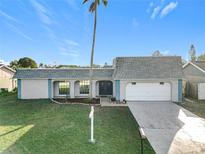 Charming single-story home featuring an attached garage and well-manicured lawn at 3640 Richboro Dr, Holiday, FL 34691