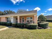 Charming single-story home with a well-manicured lawn and lush, trimmed hedges at 9332 Whitstone Ct, New Port Richey, FL 34655