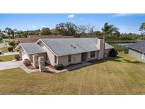 Charming single-story home featuring a well-manicured lawn and decorative stone accents on the front columns at 4513 Dewey Dr, New Port Richey, FL 34652