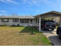 Charming single-story home with covered carport and well-maintained front yard at 5900 Beech St, Zephyrhills, FL 33542