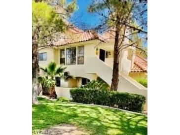 Charming multi-level home with a red tile roof and lush landscaping at 2605 S Durango Dr # 204, Las Vegas, NV 89117