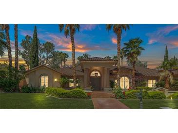 Elegant single-story home with manicured landscaping, a welcoming entrance, and a large front yard at 1813 Skyline Dr, Las Vegas, NV 89117