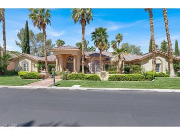 Single-story house with tile roof, columns, and landscaping at 1813 Skyline Dr, Las Vegas, NV 89117