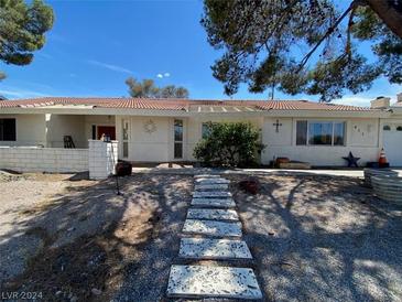 Charming single story home with well-maintained landscaping and a striking red door at 611 E Fairway Rd, Henderson, NV 89015