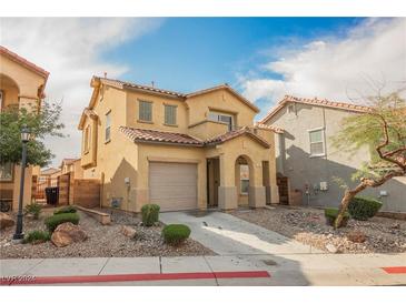 Charming two-story home featuring desert landscaping, a tile roof, and an attached garage at 1161 Gecko Rd, Henderson, NV 89002