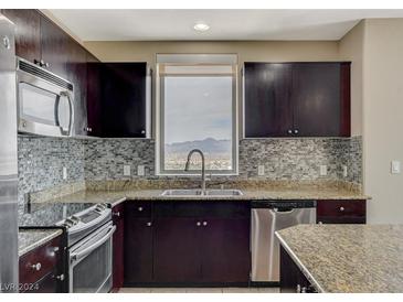 Gourmet kitchen with granite countertops, stainless steel appliances, and mountain view at 8255 S Las Vegas Blvd # 1521, Las Vegas, NV 89123